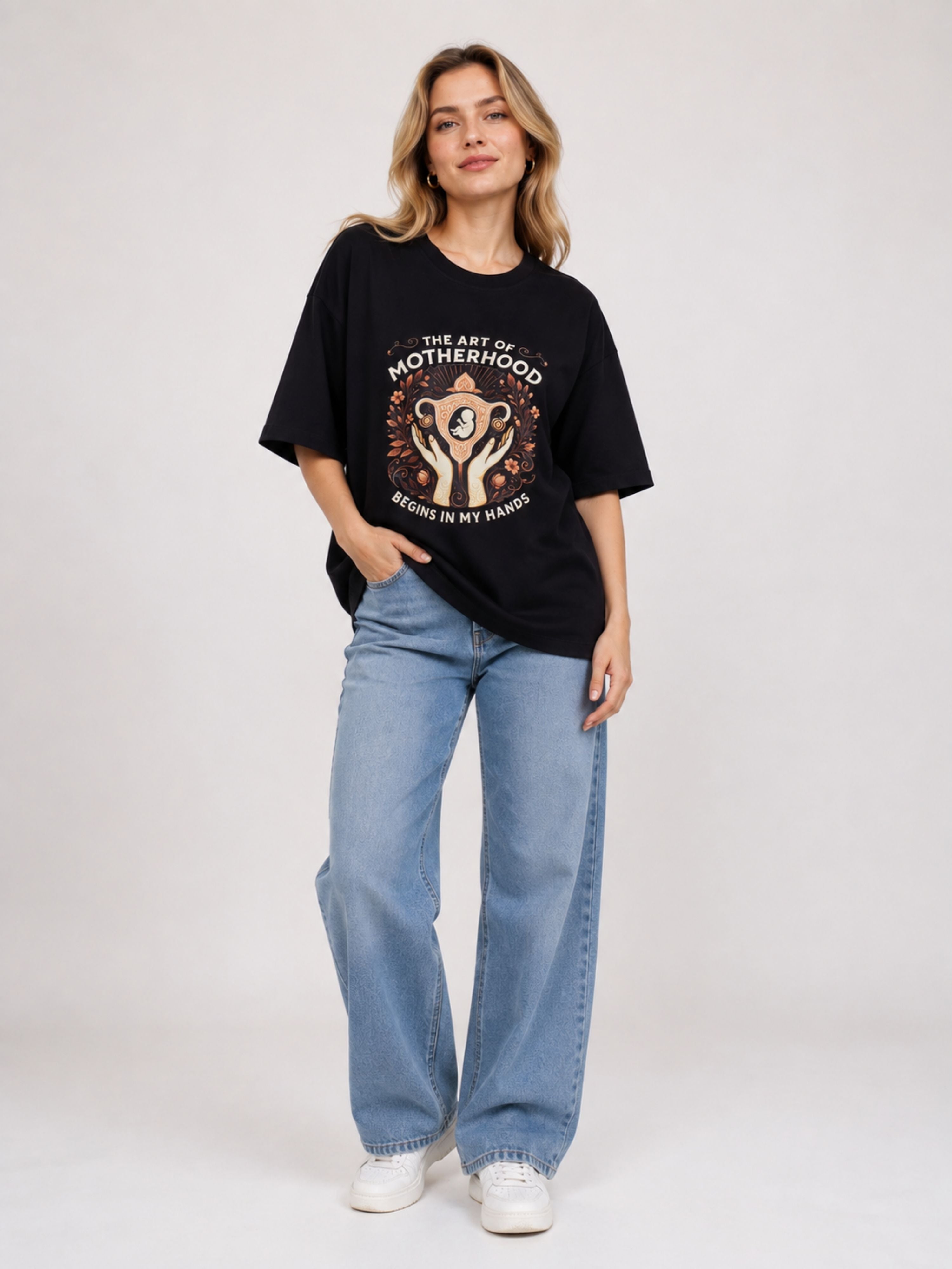 Woman wearing oversized fit Gynaecologist Printed Tshirt For Women with motherhood graphic and light blue jeans