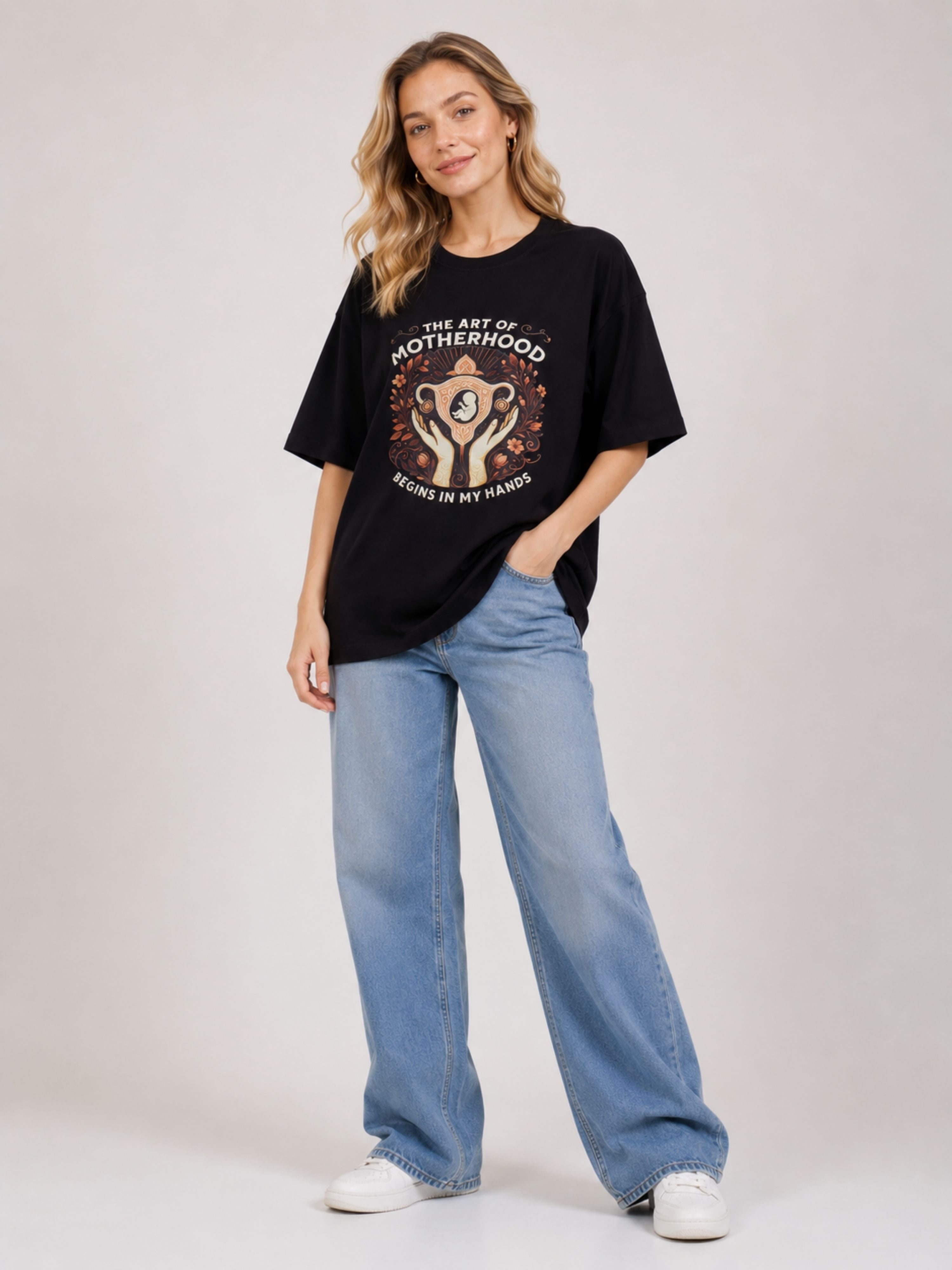 Black oversized fit Gynaecologist Printed Tshirt For Women with motherhood design worn with blue jeans