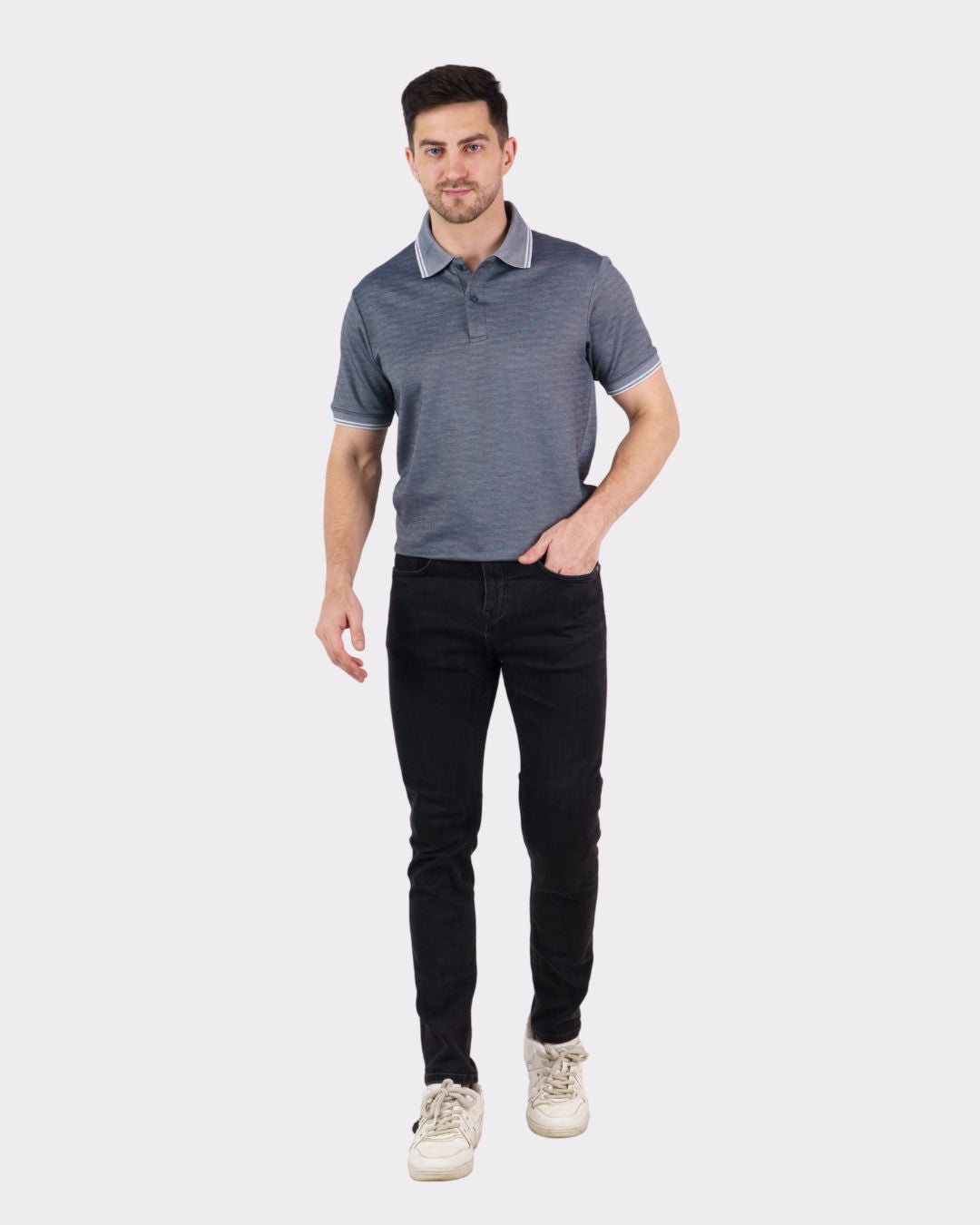 Man wearing a premium polo t-shirt for men in gray with a collar and short sleeves paired with black pants