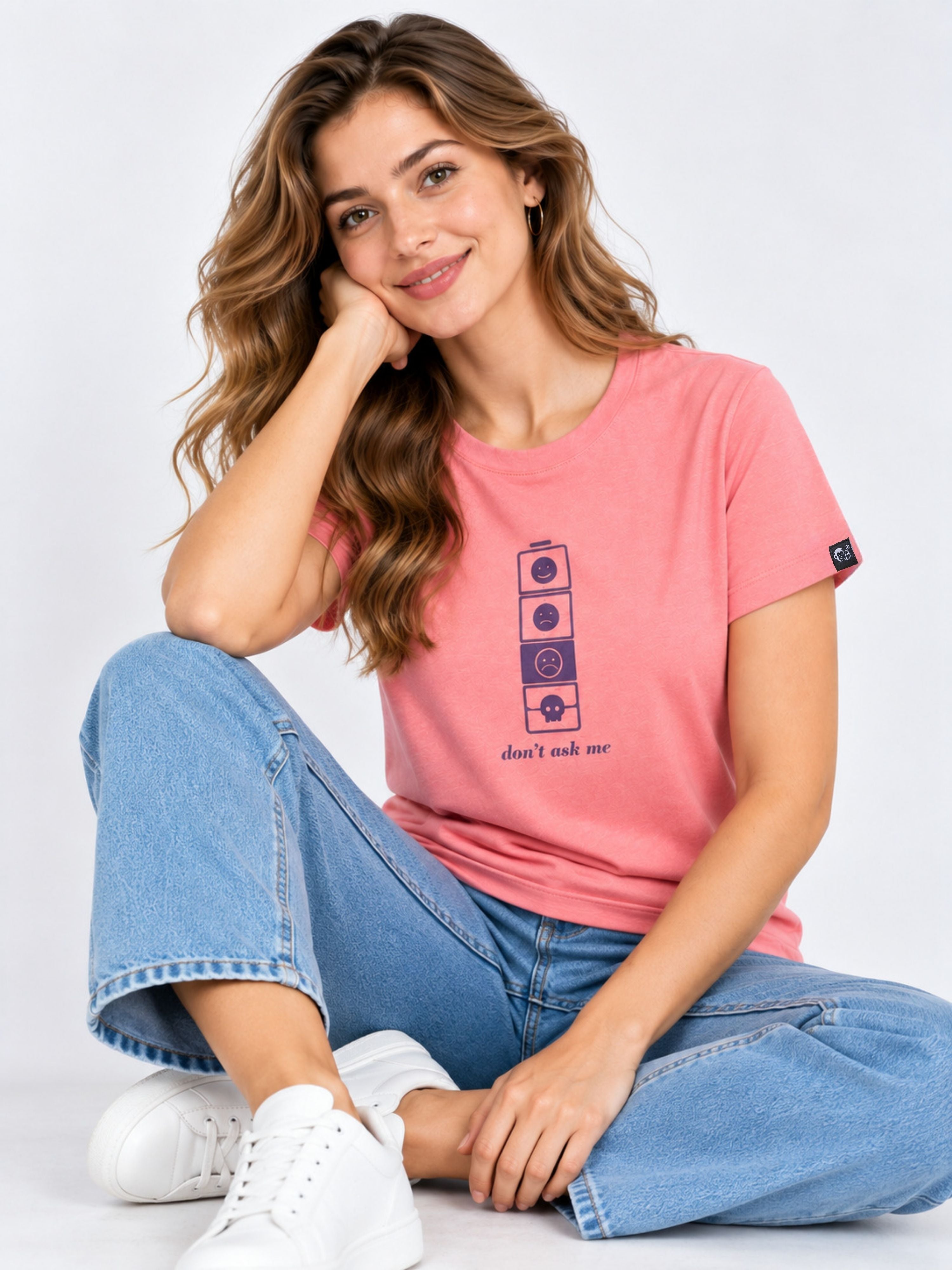Regular Fit T-shirt For Women in pink with graphic print worn by smiling woman sitting casually in jeans and white sneakers