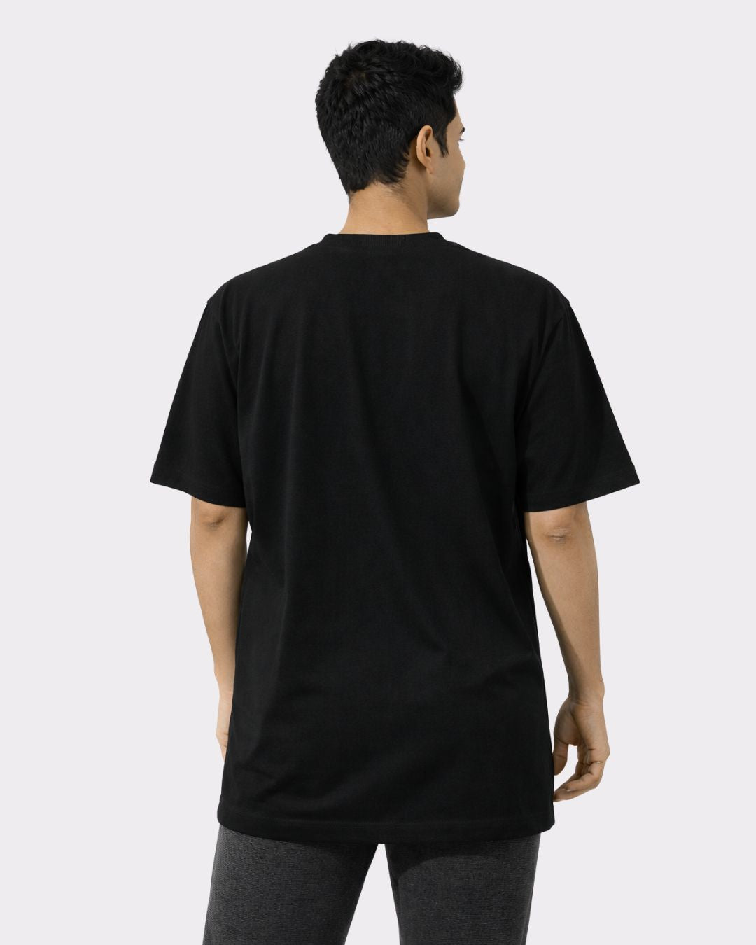 Back view of black Yoga Instructor Oversized Tshirt For Men by Bandar Baant Collections on model