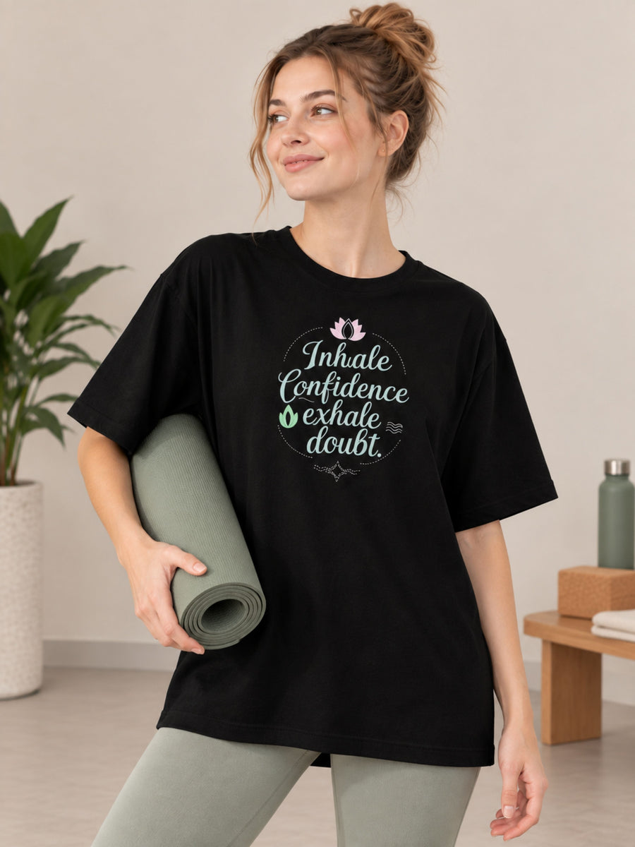 Black oversized fit Yoga Instructor T-shirt For Women with inspirational quote worn by woman holding yoga mat