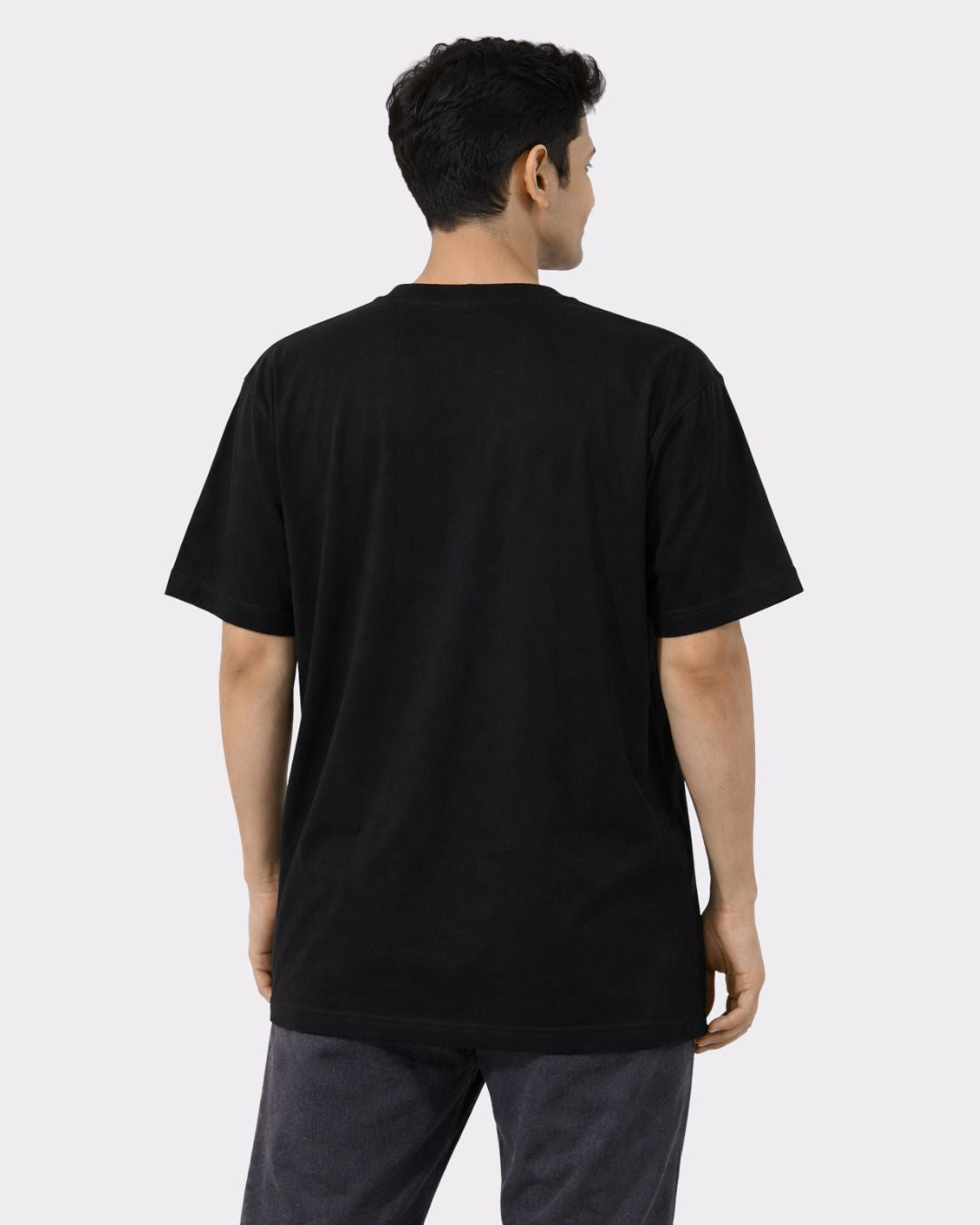 Back view of man wearing black Yoga Oversized Tendy Tshirt For Men from Bandar Baant Collections