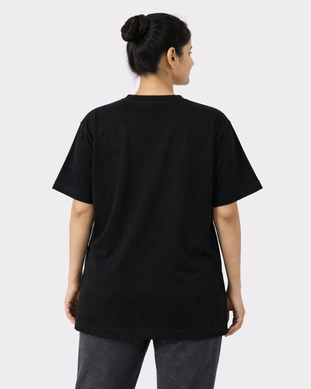 Back view of woman wearing black Yoga Oversized Trendy T-shirt For Women by Bandar Baant Collections