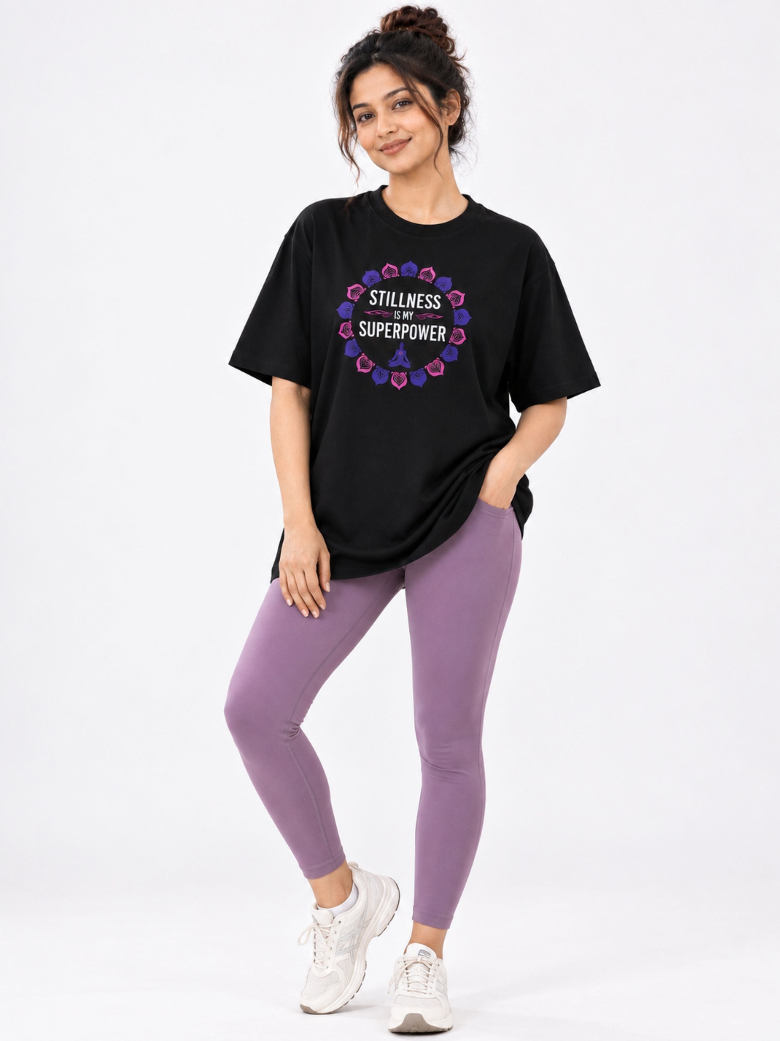 Black oversized fit Yoga Trendy T-shirt For Women with graphic text paired with purple leggings and white sneakers